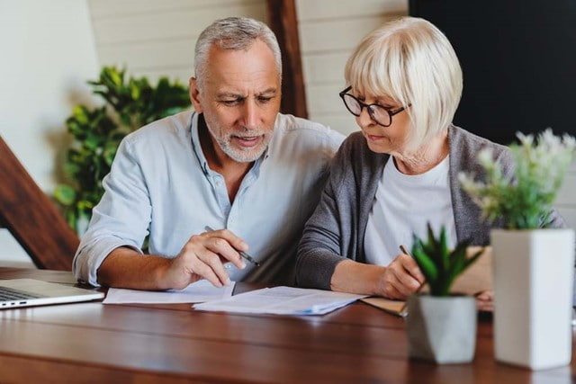 Elderly couple reviewing documents